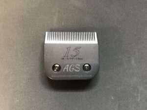 Number 1.5 metal clipper blade on gray background.