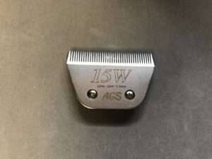 Metal clipper blade with measurement details on table.