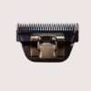 Electric clipper blade attachment on white background.