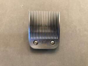 Hair clipper attachment, 3/4 inch size, on gray surface.