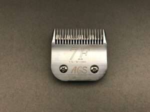 Metal clipper blade attachment labeled 7F on surface.