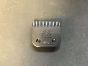 Hair clipper attachment size 8 1/2 on table.