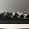 Black accordion-style cable organizer with white clips.