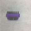 Purple hair clipper attachment on fabric.