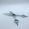 Silver hairdressing scissors with blue handles.