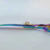 Iridescent barber scissors on white background.