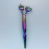 Colorful iridescent medical scissors on white background.