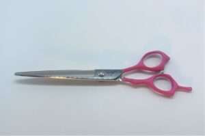 Pink-handled stainless steel scissors on white background.