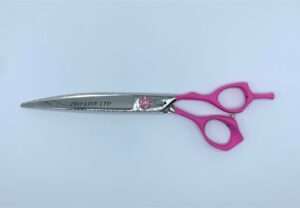 Pink-handled professional hairdressing scissors on white background.