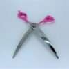 Pink-handled stainless steel scissors on white background.