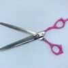 Pink-handled thinning shears on white background