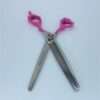 Pink-handled thinning scissors with lip-shaped grips.