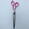 Pink-handled thinning scissors on white background