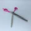 Thinning shears with pink handles on white background.