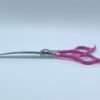 Pink-handled curved scissors on white background.