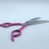Pink-handled hair cutting scissors