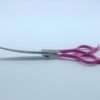 Pink-handled curved grooming scissors