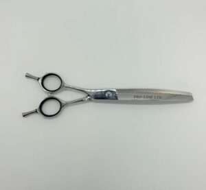 Professional hairdressing scissors on white background.