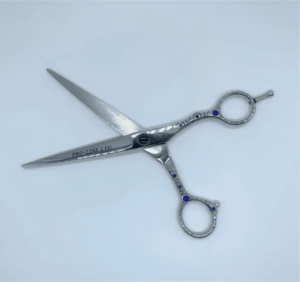 Professional hairdressing scissors on white background.
