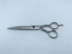 Professional hairdressing scissors on white background.