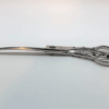 Ornate silver embroidery scissors on white background.