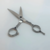 Ornate silver scissors on white background.