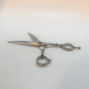 Professional hairdressing scissors on white background.