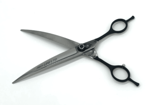 Professional black hairdressing scissors on white background.