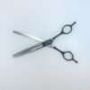 Metal hair thinning scissors on white background