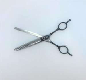 Metal hair thinning scissors on white background