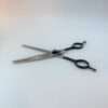 Professional hair thinning scissors on white background.
