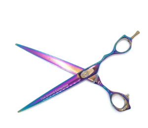 Iridescent hairdressing scissors on white background.