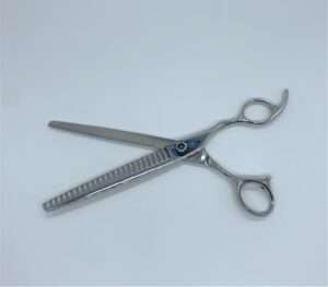 Silver hair thinning scissors on white background.