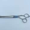 Professional hair thinning scissors on white background.