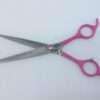 Pink-handled hairdressing scissors on white background.