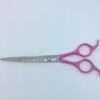 Pink-handled professional hairdressing scissors on white background.