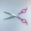 Pink-handled scissors on white background