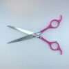 Pink-handled scissors on white background