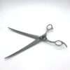 Curved hairdressing scissors on white background.