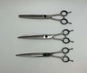 Two professional hairdressing scissors on white background.
