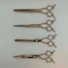 Professional hairdressing scissors on a white background.