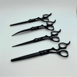 Black professional hairdressing scissors on white background.