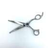 Professional hairdressing scissors on white background.