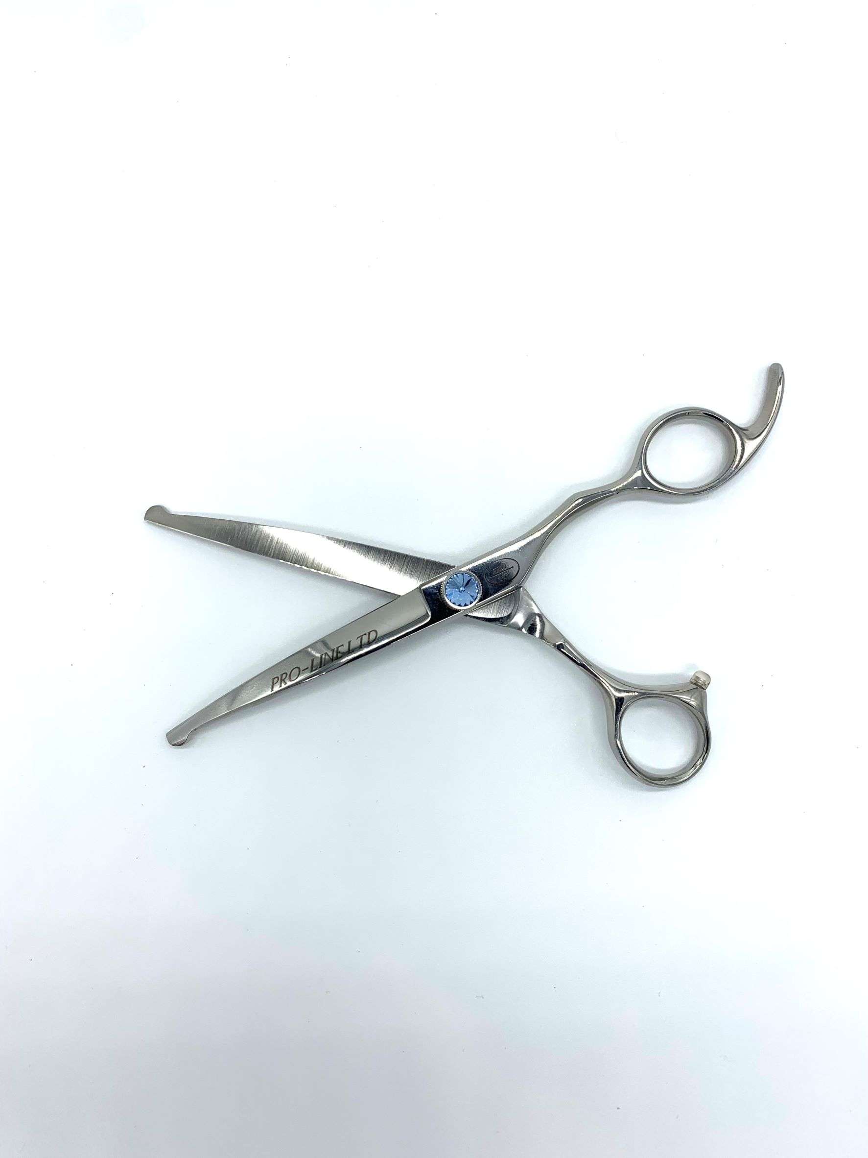 Professional hairdressing scissors on white background.