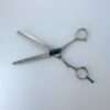 Professional hair thinning scissors on white background