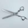 Professional hair thinning scissors on white background.
