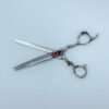 Professional hair thinning scissors on white background.