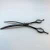 Curved hairdressing scissors on white background