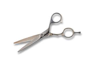 Professional hairdressing scissors on white background.