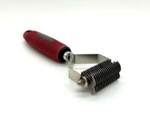 Peeler with red handle on white background.